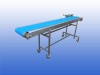 Gebruikte RVS transportband 30 cm breed 2,55 meter lang met onderstel op wielen